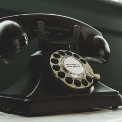 Black Rotary Telephone on White Surface Black Rotary Telephone on White Surface
